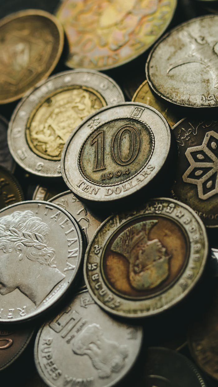 Closeup of old golden and silver coins placed in heap next to each other